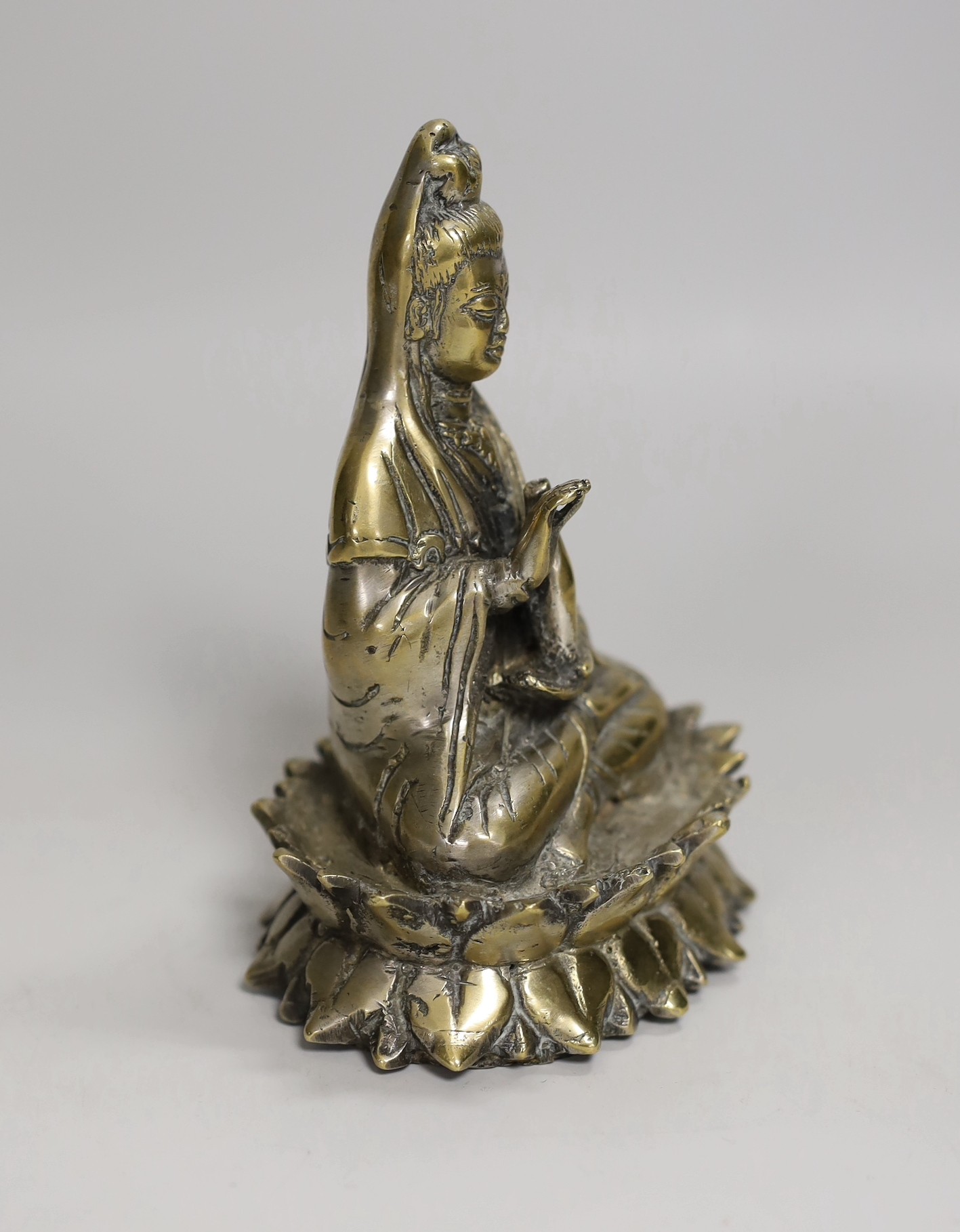 A Chinese bronze seated figure of Guanyin, 13cm